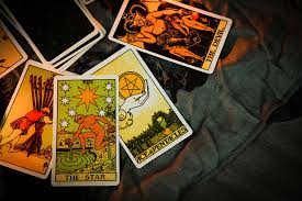 An aesthetic spread of tarot cards on a dark surface