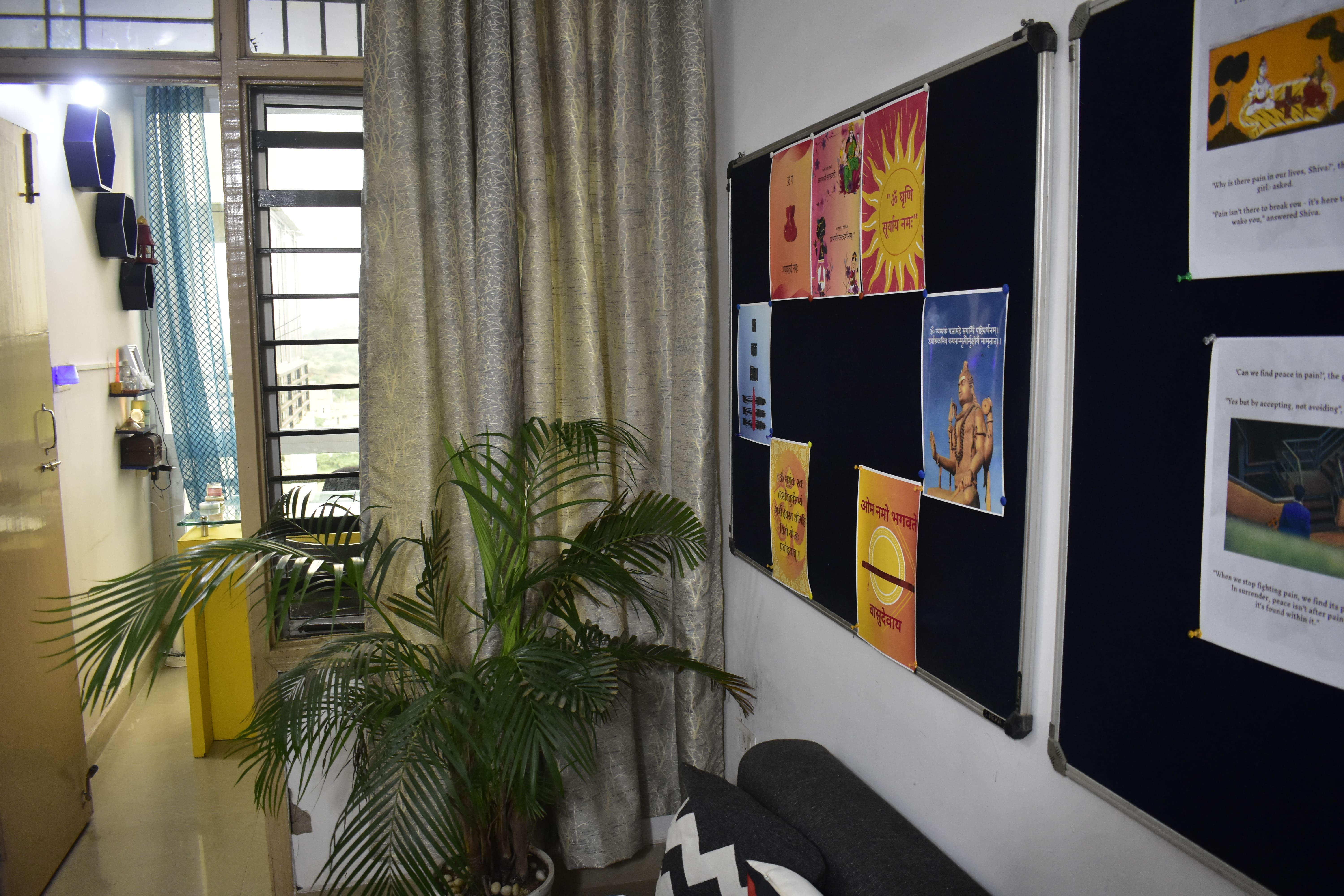 Ashavan interior with a plant and notice board